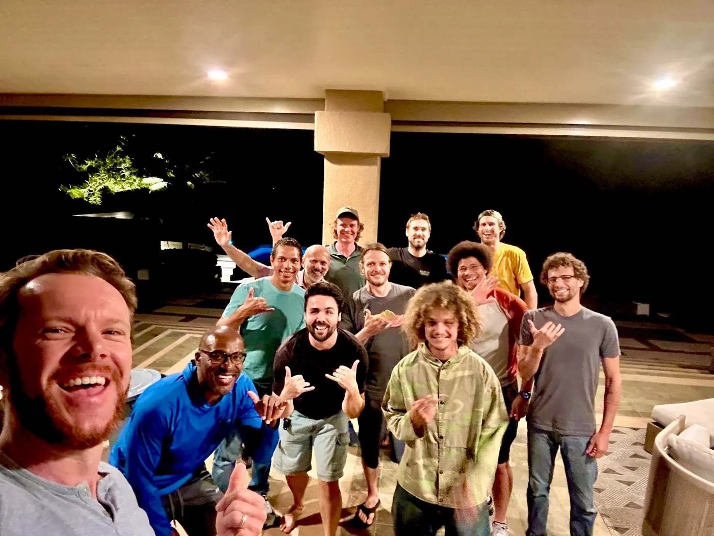 Men smiling together after a real Brotherhood gathering at night.