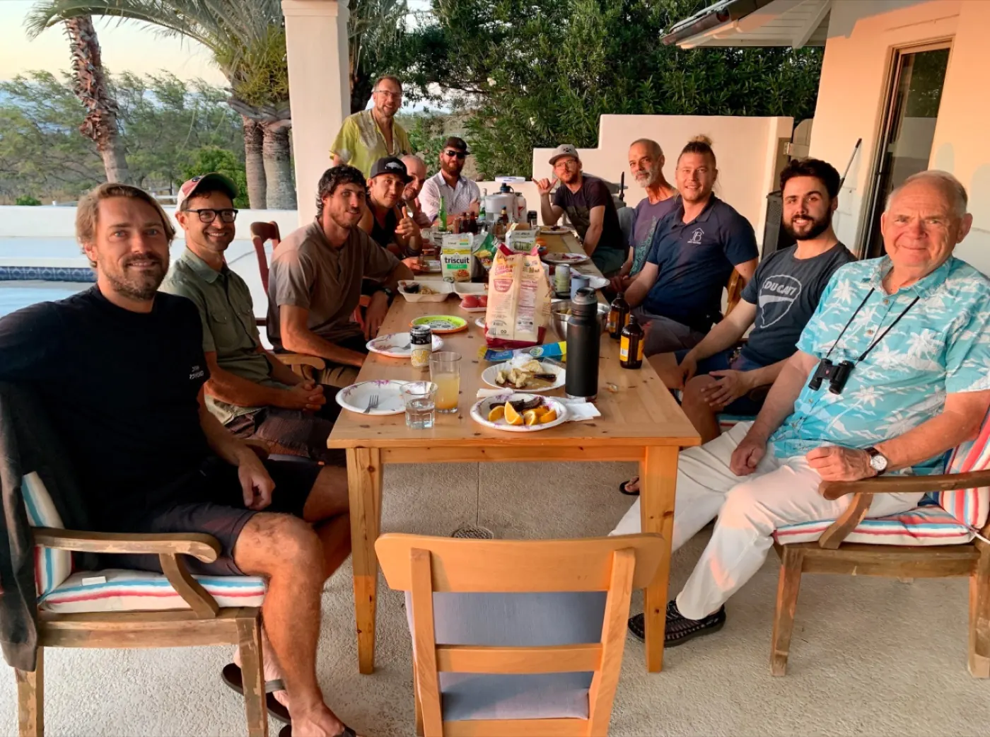 Men gathered around a shared table, representing the invitation into real Brotherhood.